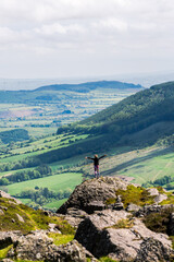 Woman with raising his arms triumphant in mountain of Ireland