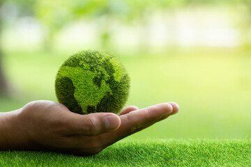 Close up hands holding earth on green background.protect nature.Save Earth.concept of the...