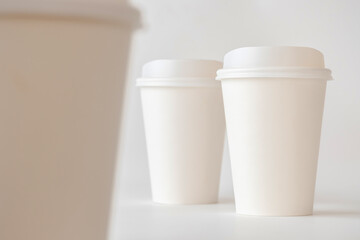 Three White Paper Coffee cups on White Background, Coffee Cup Mock up.