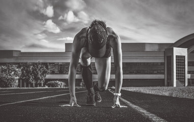 Image of a girl standing on the start line of the track. Running concept.