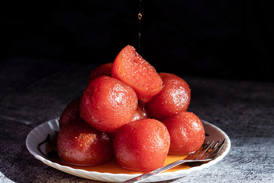 Indian sweets - Gulab Jamun in plate on dark background