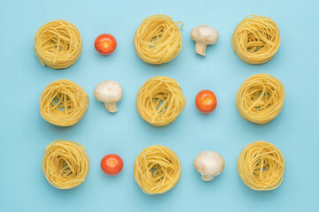 Background of tomatoes, mushrooms and twisted pasta on a blue background.