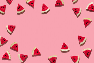 fresh slices of watermelon on a pink background hard shadows of the sun. minimal concept of travel and vacation with copy space