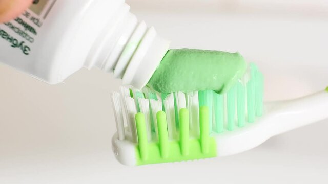 toothpaste is smeared on a toothbrush