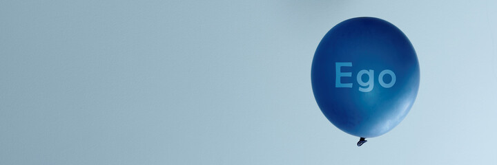 Word Ego inscription on blue balloon inflated. Banner with copy space.
