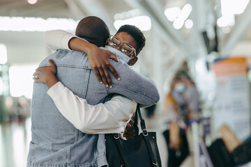 Couple giving good bye hug at airport
