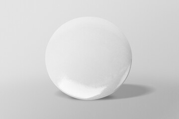 Round white pin on gray background