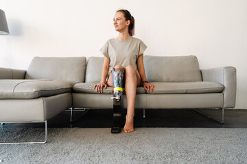 Smiling young white disabled woman with prostetic leg