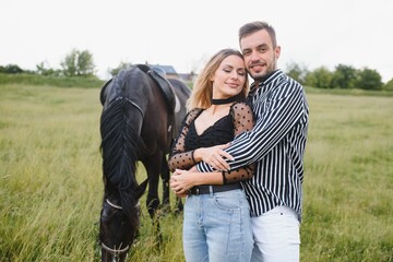 loving couple with horse on ranch