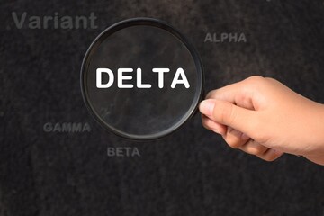 New covid-19 delta variant strain symbol. Female holds a magnifying glass in his hand.