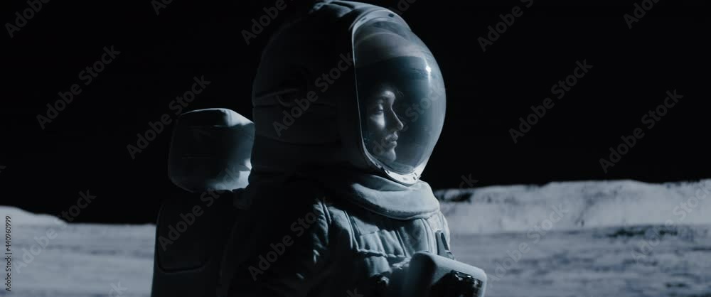Wall mural cu portrait of caucasian female lunar astronaut opens her visor while exploring moon surface. shot w