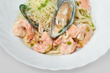 Spaghetti cooked with shrimps, mussels and cheese in creamy sauce. Seafood