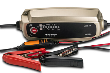 Portable battery chargers instrument with input  output cables and jumpers on white background.