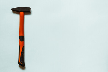 The black and orange hammer lies alone on a white background with plenty of room to insert.