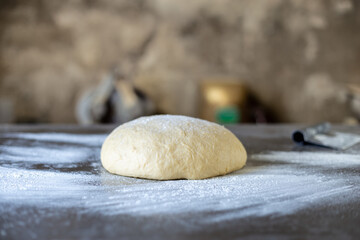 Fototapeta na wymiar Dough makes fresh bread on the kitchen table.