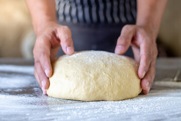 Dough makes fresh bread on the kitchen table.