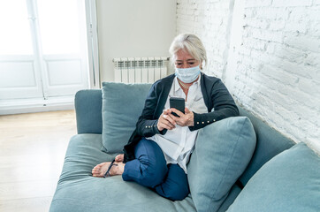 Depressed senior woman with facemask feeling lonely after loosing husband due to coronavirus