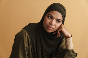 Black muslim woman in hijab posing and looking aside