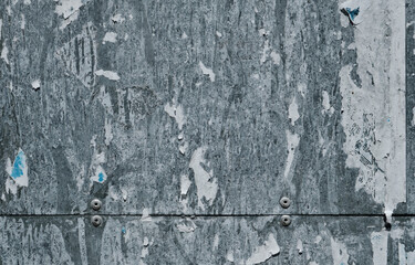 Old metallic bulletin board with peeled paper