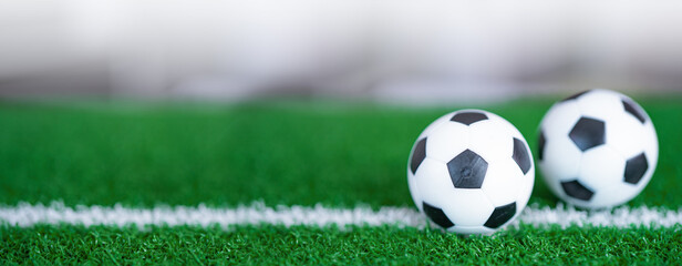 Obraz premium Football on green lawn or field, most popular sport in the world.