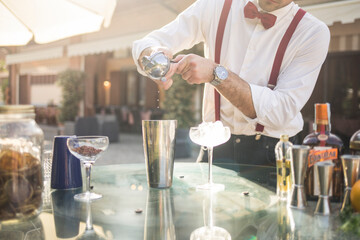 Barman is making a cocktail outdoor