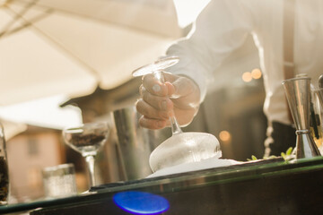 Barman is making a cocktail outdoor