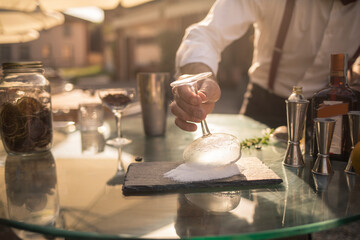 Barman is making a cocktail outdoor