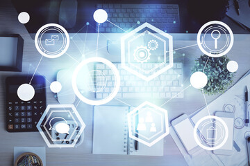 Social network hologram drawings over computer on the desktop background. Top view. Multi exposure. Concept of people connection.