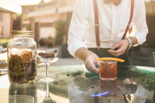 Barman is making a cocktail outdoor