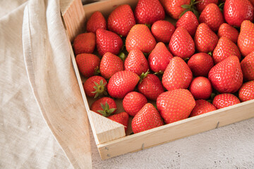 Frische Erdbeeren in Holz Kiste für Lager auf Leinentuch und Marmor Hintergrund hell - obrazy, fototapety, plakaty