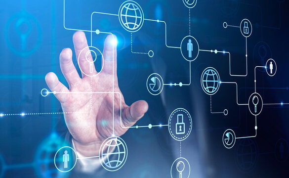 Businessman hand touching digital interface on holofram screen by finger. Social media and data security icons on background. Concept of networking and cooperation