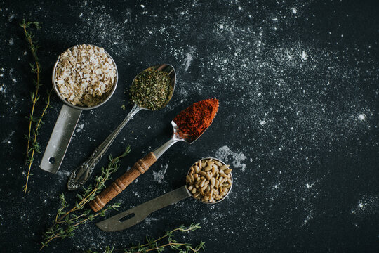 Assorted spices and seeds on black table