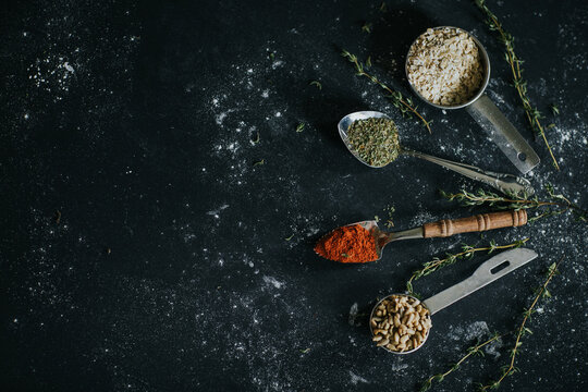 Assorted spices and seeds on black table