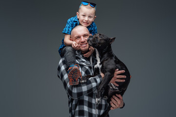 Studio shot of family of boy father and dog