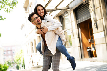 Happy young couple outdoors. Loving couple walking in the city.