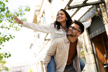 Fototapeta premium Happy young couple outdoors. Loving couple walking in the city.