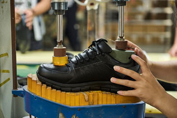 Woman's hands in quality control production line in Chinese shoe