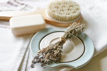  Bath accessories on a white towel. Daily body care concept, organic bath products. Aromatherapy with hers in a bathroom      