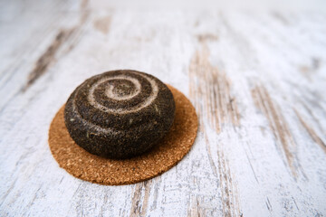 Isolated eco friendly, natural handmade solid shampoo for hair on a wooden plate. Concept animal fat free, zero waste. Homemade toxic-free organic cosmetic. Empty space for text.