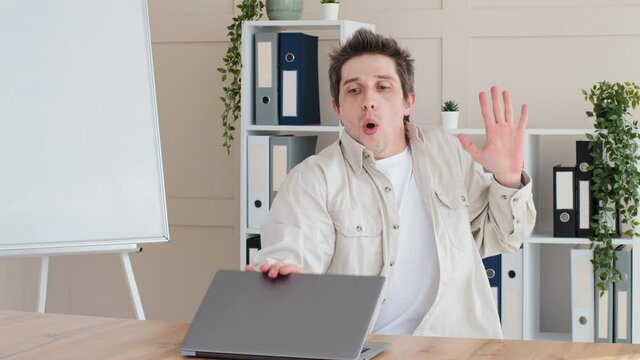 Caucasian millennial adult business man get ready for work male freelancer sitting at table in home office opens laptop frightened feels fear awe horror afraid scared closes computer sighs with relief