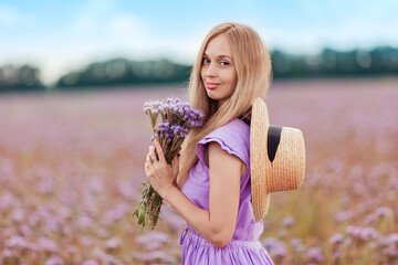 Beautiful girl in a field with flowers
