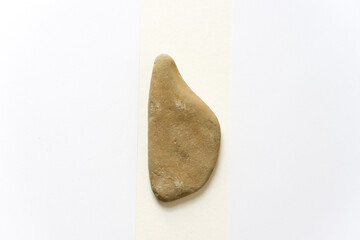 sand stone placed between two fields of white paper - with space for text