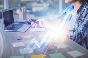 Double exposure of woman hands typing on computer and arrows drawing. Success concept.