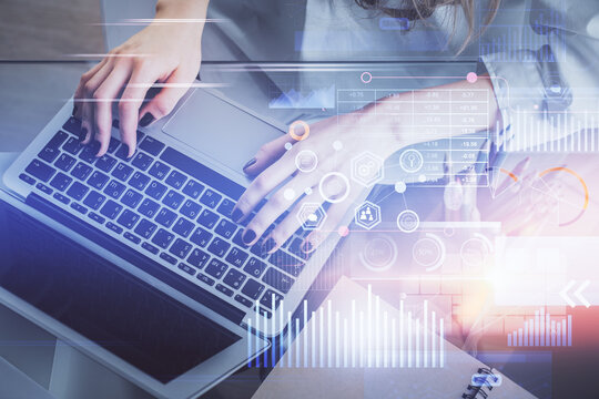 Double exposure of woman hands working on computer and data theme hologram drawing. Tech concept.