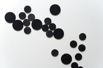 round wooden shapes hand painted - arranged in a loose composition on a light ground - photographed in a top-down orientation