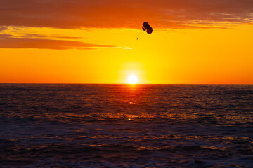 parachutist against the background of the sea sunset