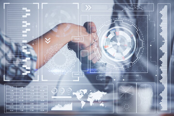 Double exposure of data theme hologram and handshake of two men. Partnership in IT industry concept.