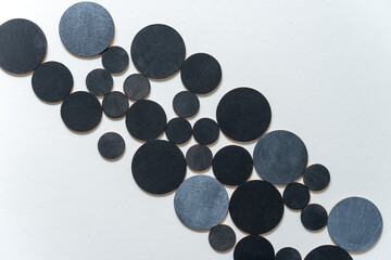 round wooden shapes hand painted - arranged in a loose composition on a light ground - photographed in a top-down orientation