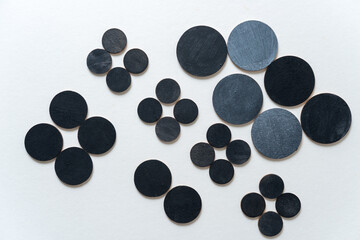 round wooden shapes hand painted - arranged in a loose composition on a light ground - photographed in a top-down orientation