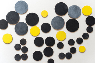 wooden shapes hand painted in yellow, silver gray, and flat black - arranged in a loose composition...